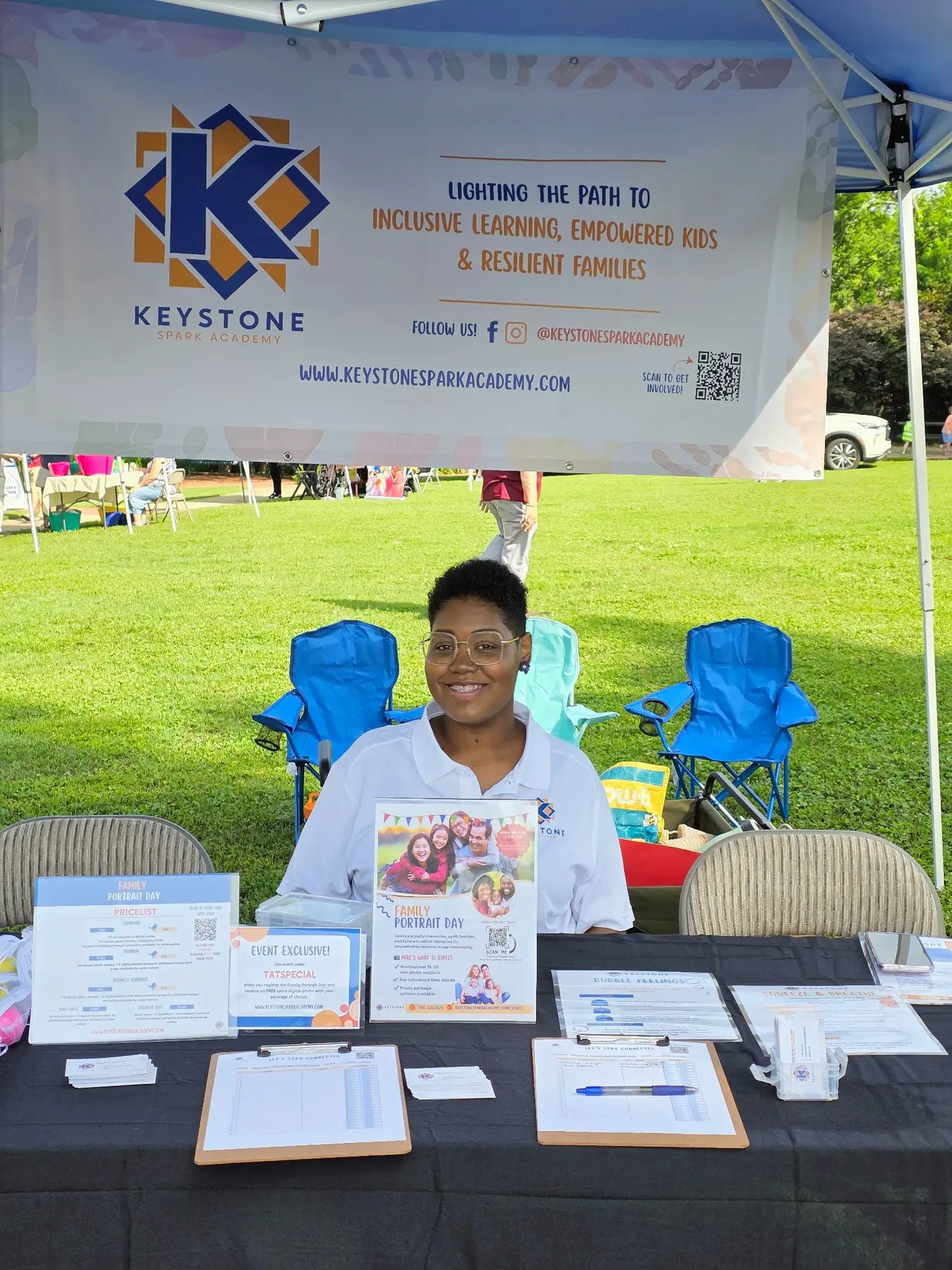 Andrea Cesar welcoming visitors at the Keystone Spark Academy community booth